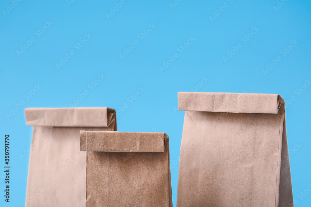 Paper bags on color background