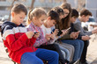 © JackF - Children addicted in their phones outdoors