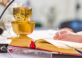 Wall Mural - altar with host and chalice with wine in the churches of the pope of rome, francesco