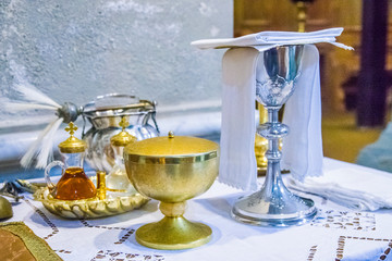 Wall Mural - chalice for wine, blood of christ, and ciborium with host, body of christ, and ampoules with wine and water for consecration