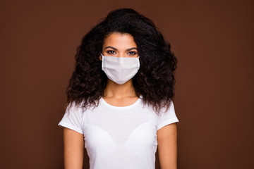 Wall Mural - Portrait of charming lovely afro american girl look good enjoy emotions wear casual style outfit facial protective flu mask isolated brown color background