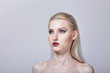 © Evgenia - A beautiful girl with light natural hair looks to the side. Bright make-up.