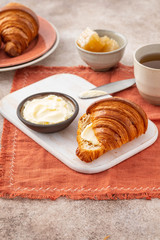 Wall Mural - Fresh croissants with blueberries and honey, gray background.