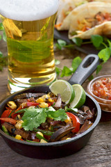 Wall Mural - fajitas with salsa and a glass of beer