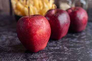 Wall Mural - Red apples on the black cement floor. Selective focus.