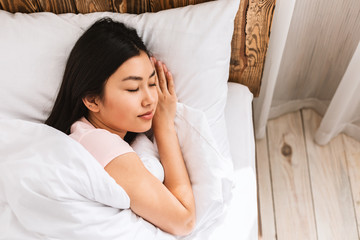 Japanese Woman Sleeping Lying In Comfortable Bed Resting In Bedroom