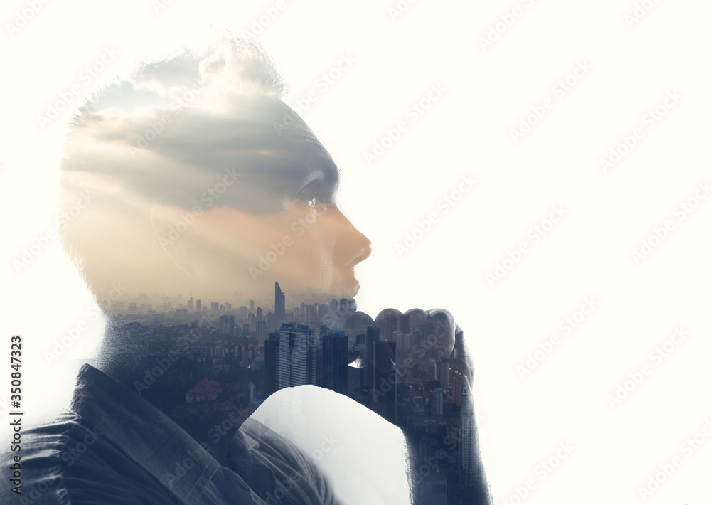 Double exposure portrait of a man in contemplation at sunset time above the city - obrazy, fototapety, plakaty 