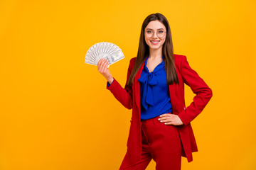 Poster - Photo of fancy pretty business lady hold hand fan bucks money rich successful person worker wear specs red luxury office blazer blue blouse suit pants isolated yellow color background