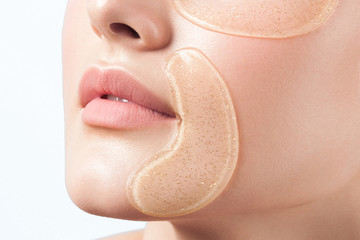 Poster - Young beautiful woman with clean perfect skin with cosmetic patches on face close-up