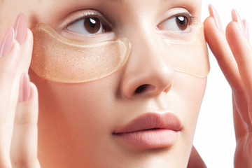 Poster - Young beautiful woman with clean perfect skin with cosmetic patches on face close-up