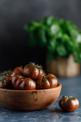 Wall Mural - Fresh tomatoes in a plate on a dark background. Harvesting tomatoes.