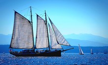 Idyllic View Of Large Sailing Ship In Sea Against Blue Sky