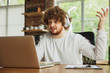 © master1305 - Businessman or student working from home being isolated or keep quarantine 'cause of coronavirus. Caucasian man using laptop, tablet, phone and headphones. Online conference, lesson, remote office.