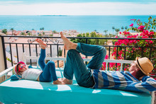 Father And Little Daughter Relax On Balcony Terrace