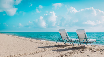 Wall Mural - Two beach chairs on tropical vacation, relax at sea