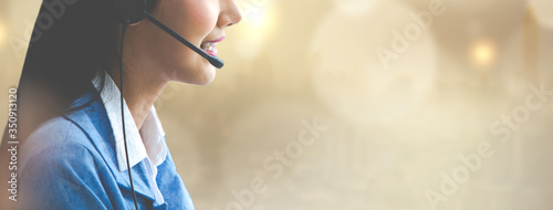 Fotografía Attractive business woman Asian in suits and headsets are smiling while working with computer at office