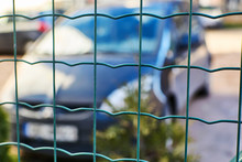 Car Behind The Fence Net. Parking, Fine Area.