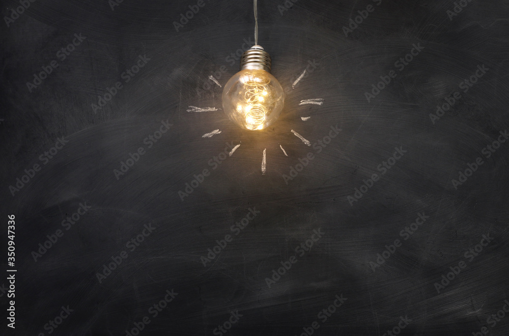 Education concept image. Creative idea and innovation. Light bulb as metaphor over blackboard - obrazy, fototapety, plakaty 