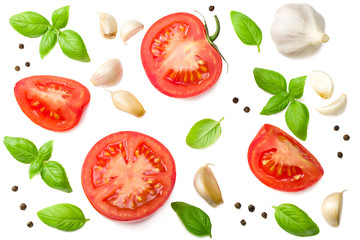 tomato slices with garlic and basil isolated on white background, top view