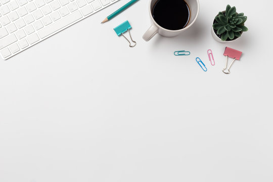 Top view, Workspace desk With coffee and office supplies on white background