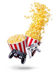 Wall Mural - Flying popcorn and video game joystick gamepad isolated on a white background