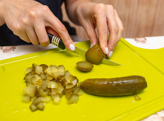 Sticker - The girl cuts pickles with a knife