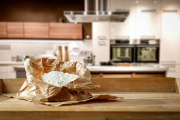 Wall Mural - Flour on the table in a beautiful new kitchen with free space for an advertising product