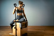 © Georgii - combo wunda pilates chair woman instructor fitness yoga gym exercise. Copy space. sports banner