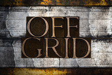 Photo Of Real Authentic Typeset Letters Forming Off Grid Text On Vintage Textured Grunge Silver And Gold Background
