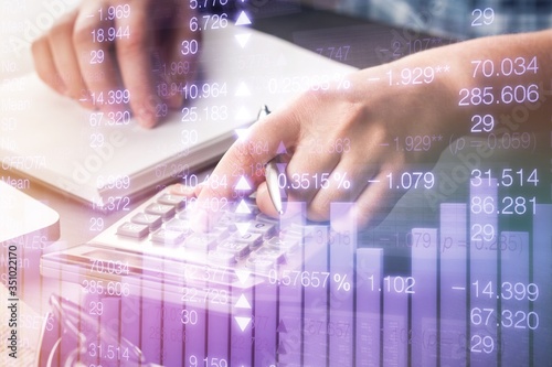 Cuadros en Lienzo Woman hand do analytics calculation on a calculator
