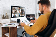 © Kateryna - Online business meeting. A young business man communicates by video conference with his business team about a work strategy and plan. Work from home