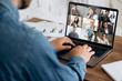 © Kateryna - Online learning. A young guy learns online by video conference using laptop. On the screen, the teacher tells the information to him and other participants in the conference