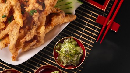 Wall Mural - Fried Fish Fingers on black background. Japanese food with smoke. Top view.