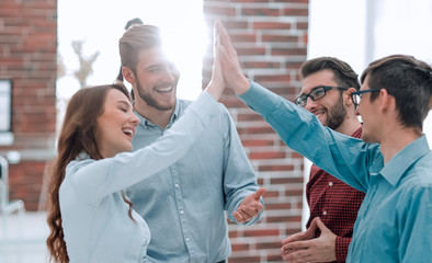 Wall Mural - happy creative business people giving high-five in meeting room.