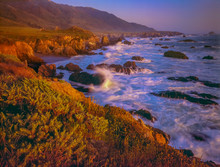 The Rocky Pacific Coastline Glow In Evening Light.
