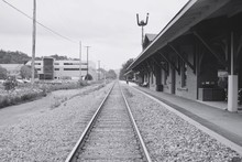 Railroad Tracks By Station Against Sky