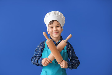 Sticker - Portrait of little chef on color background