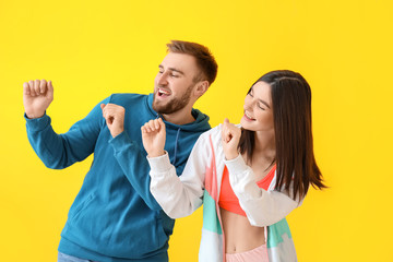 Sticker - Happy young couple dancing against color background