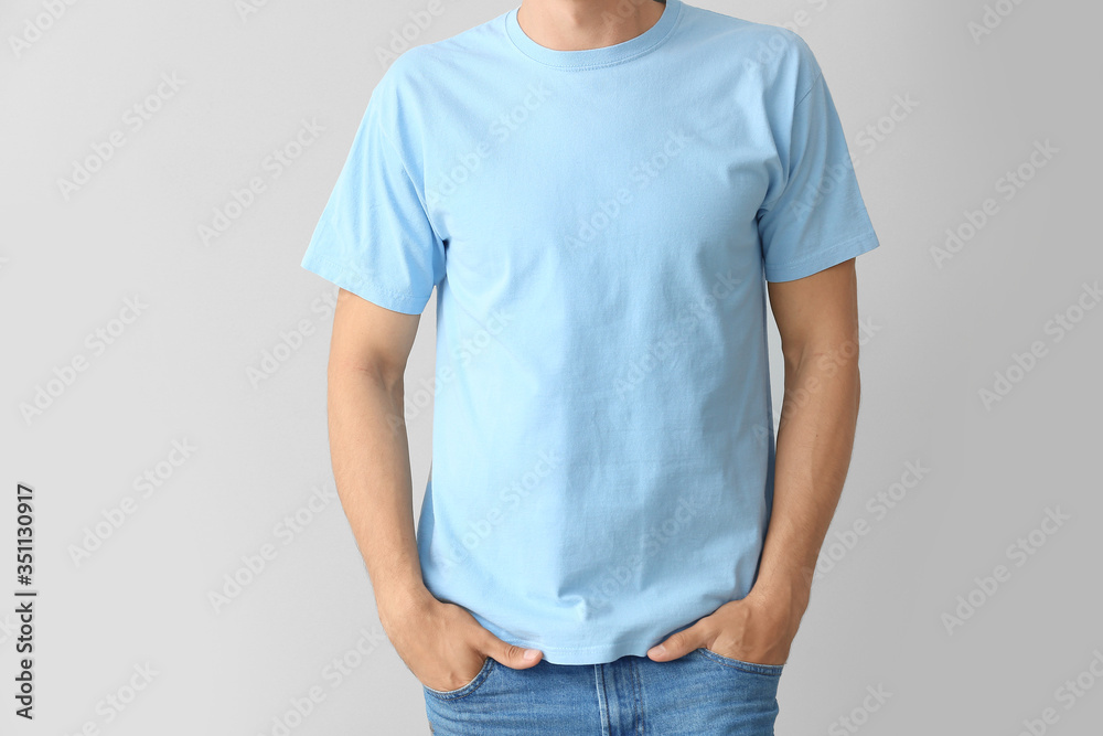 Man in stylish t-shirt on grey background