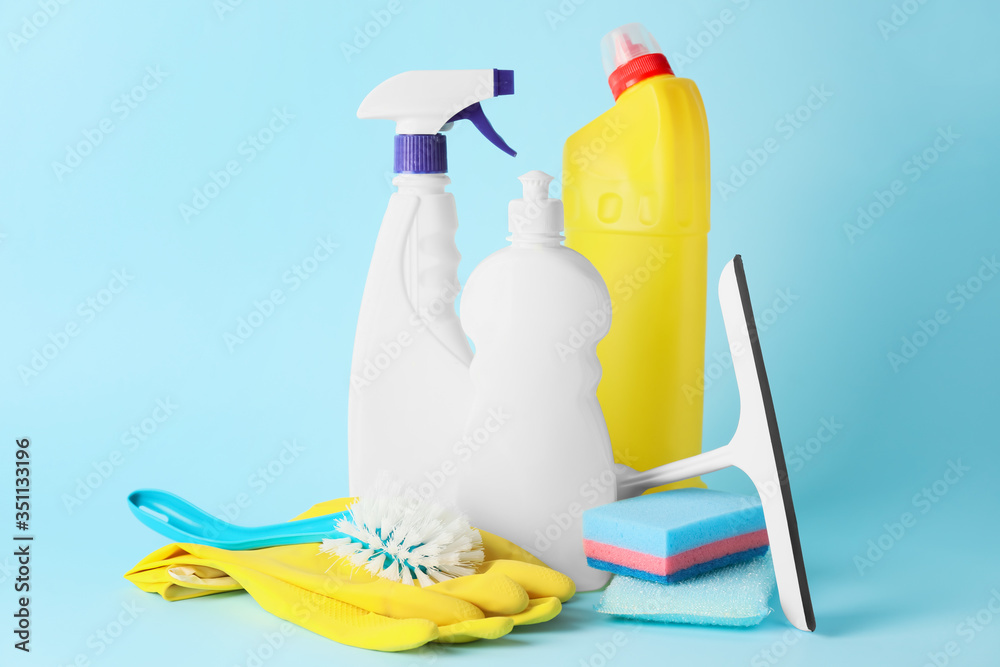 Set of cleaning supplies on color background