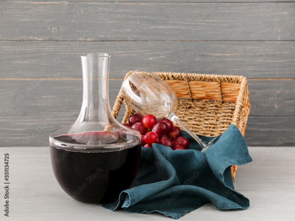 Decanter of wine on wooden background