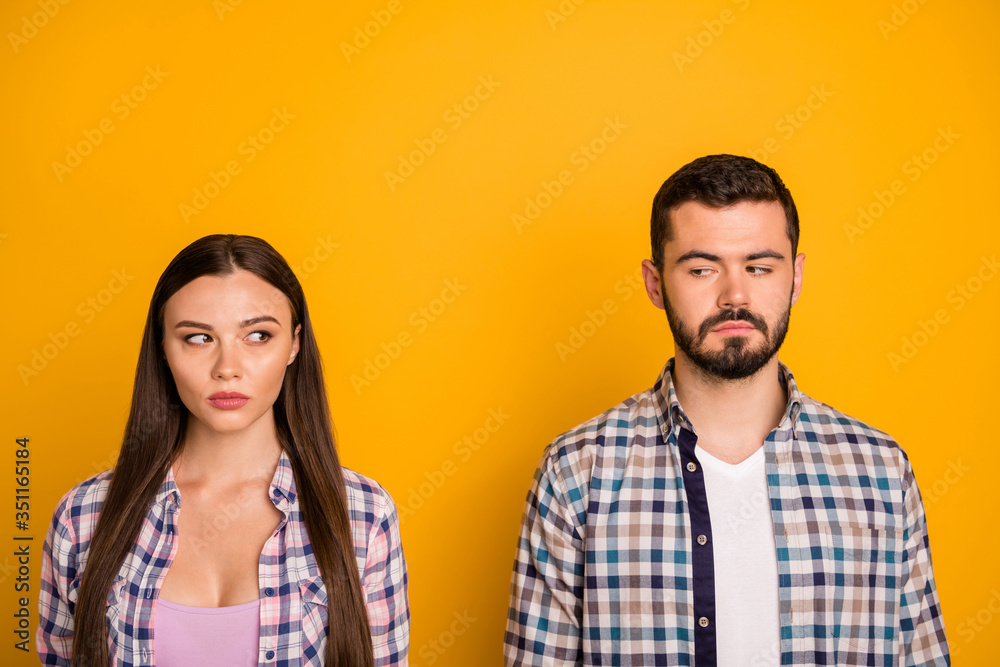 Closeup photo pretty lady handsome guy couple stand keep distance not smiling look eyes suspicious responsible people citizens wear casual plaid shirts isolated yellow color background - obrazy, fototapety, plakaty 