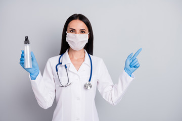 Poster - Portrait of her she nice attractive confident girl doc therapist holding in hand bottle medical alcohol showing ad advert copy space sale consultation isolated over grey pastel color background