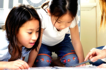 Wall Mural - Two girls learning some educational stuff