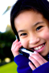 Poster - Close-up picture of girl smiling while talking on the handphone