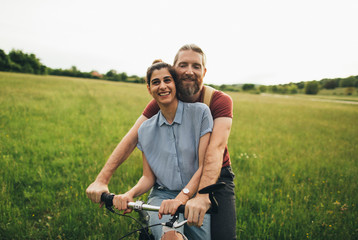 Happy couple enjoying bicycle ride together