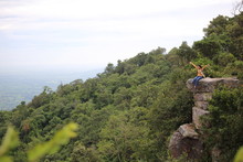 Woman Sitting On A Cliff At Mor Hin Khao National Park In Chaiyaphum, Thailand
