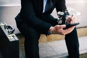 young investor or business man using digital mobile smartphone with virtual digital icon and briefca