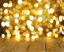 Blurred View Of Gold Lights And Wooden Table, Bokeh Effect