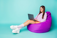 Full Body Profile Photo Of Charming Lady Sit Comfy Bean Bag Chair Hold Notebook Freelance Working Wear Purple Sweater Orange Skirt Sneakers Socks Isolated Teal Color Background